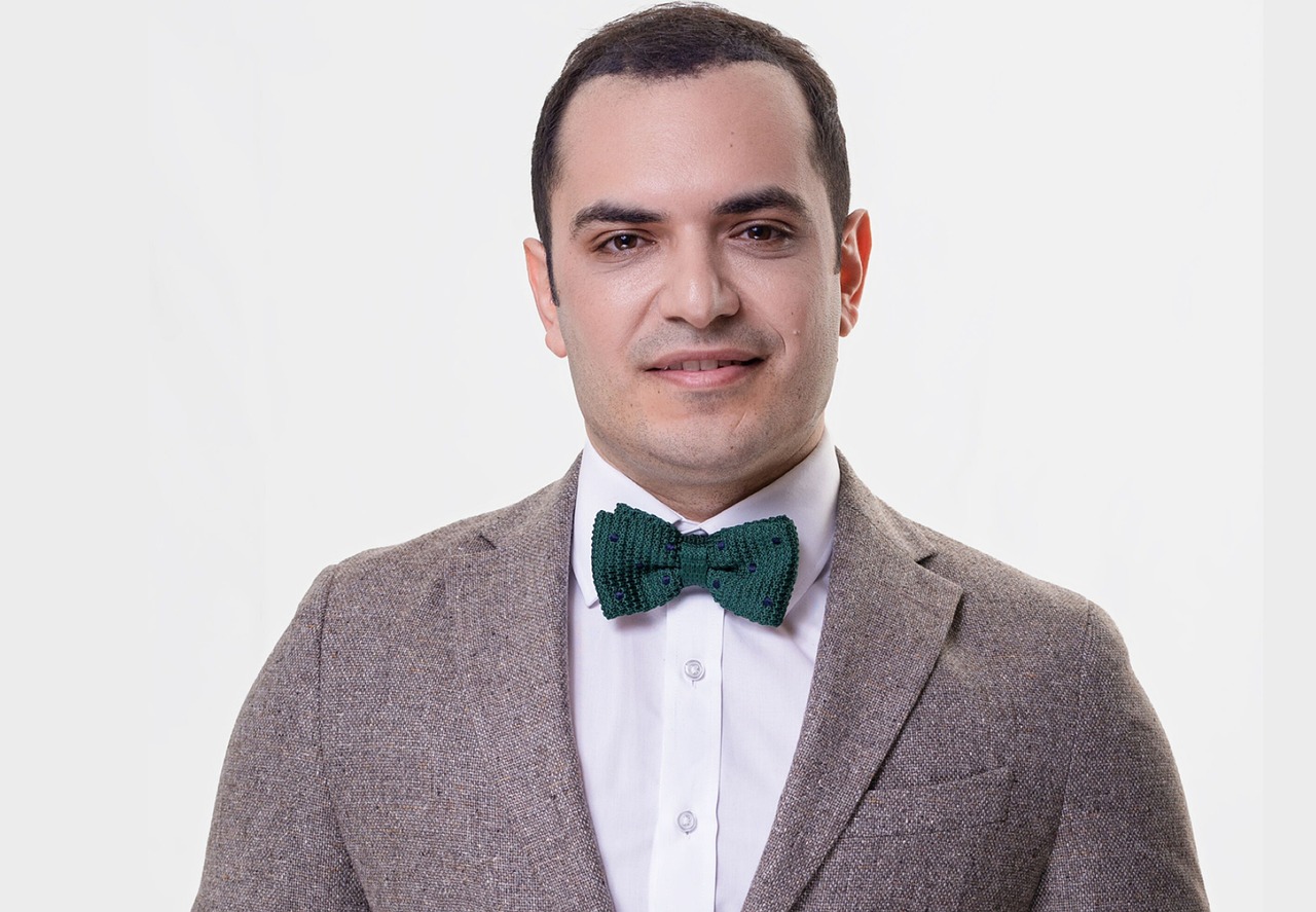 CEO smiling in formal suit and bow tie
