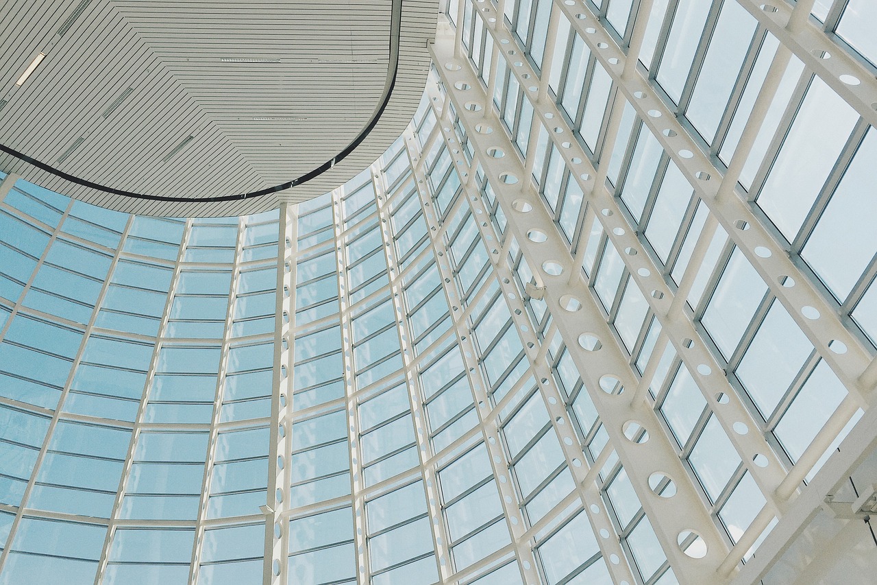 Modern steel and glass aviation hangar interior, high‑ceilinged
